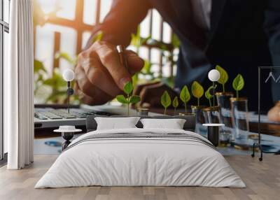 Businessman symbolically adding green leaves to coins, concept of financial growth and sustainability Wall mural