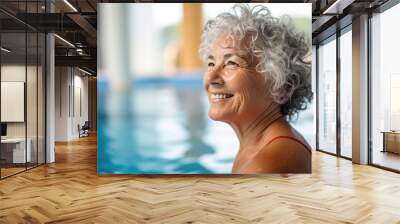 Cheerful senior woman swiming in pool Wall mural