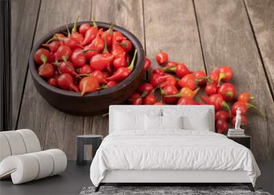 Red pepper pout on a bowl over wooden table Wall mural