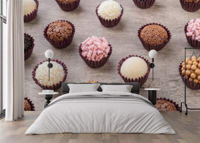 Typical brazilian brigadeiros, various flavors over wooden table Wall mural