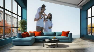 asian family having fun at sunrise enjoy vacation Wall mural