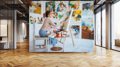 asian female artist painting on canvas doing some art projects on her studio workshop Wall mural