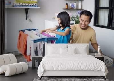 asian man father householder and child daughter in laundry drying clothes Wall mural