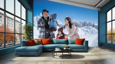 beautiful asian family walking together in landscape cover with wonderful snow Wall mural