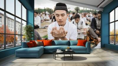 close up a man praying during Eid al-Fitr together, celebrating the religious ceremonies of Islam Wall mural