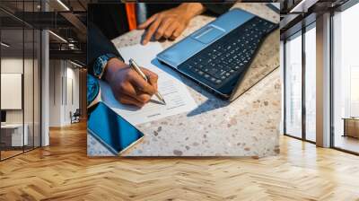 close up of hand with suit signing on a paper document with laptop Wall mural