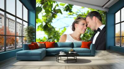 delighted bride and groom flirting each other Wall mural