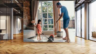 father and daughter clean up the house together sweep the floor Wall mural