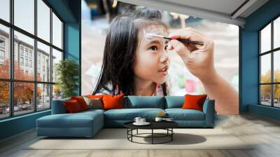 happy asian Child preschooler with face painting. Make up. Wall mural