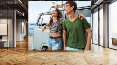 Hipster couple relaxing on her summer road trip Wall mural