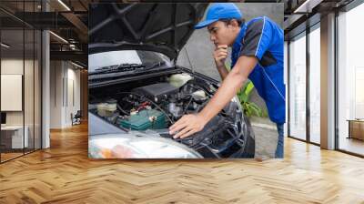 mechanic doing some inspection on car's engine  Wall mural