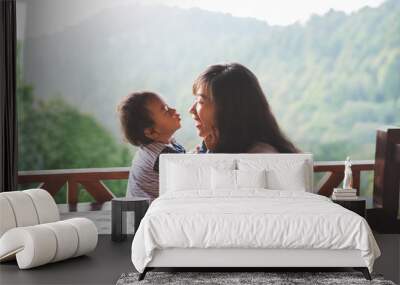 mother playing with daughter Wall mural