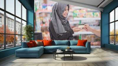 muslim woman working at supermarket Wall mural