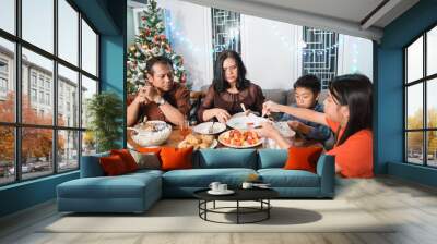 portrait of indonesian family having christmas eve dinner together at home Wall mural