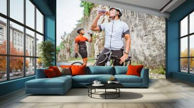 road bike cyclist take a brake and drink a bottle of water Wall mural