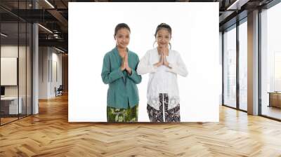 two young girl smiling and give greetings isolated in white background Wall mural