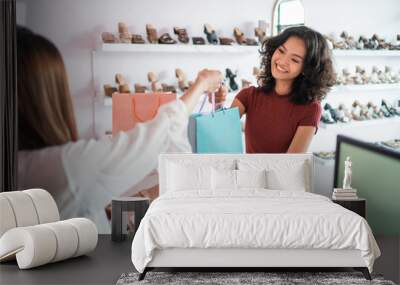 woman shopping at boutique store in the mall. shopping woman take paper bag Wall mural