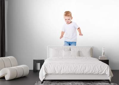 Little cute kid baby boy 3 years old, football fan in white t-shirt playing with soccer ball isolated on white background.  lifestyle concept. Copy space for text Wall mural