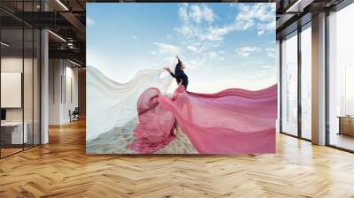 Slim Woman at the beach with long pink fabric. Sky background at the summer. Classic dancer on the nature  Wall mural