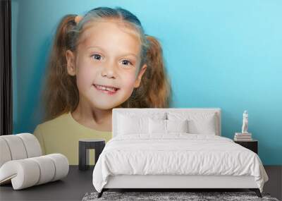 Sweet little girl child has lost the first lower milk teeth. Childhood oral hygiene, toothless smile. Wall mural