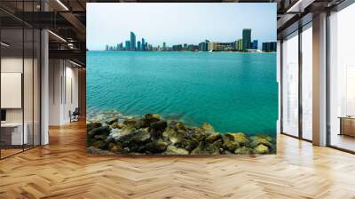 Skyline of Abu Dhabi with the Qasr Al Amwaj theater, UAE and stones on the foreground Wall mural