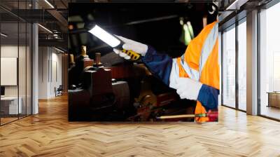 closeup engineer or technician using light stick and checking construction train at station Wall mural