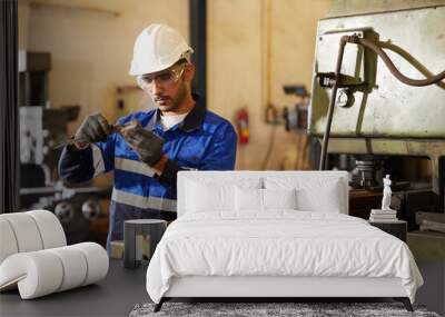 engineer or factory worker using calipers measures in the factory Wall mural