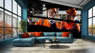 engineers or technicians working and checking construction inside under a train Wall mural