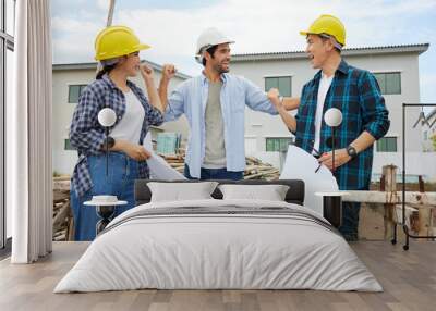 group of workers or architect celebrating success at work and project on the construction site Wall mural