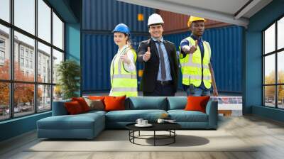 portrait factory workers or engineers thumbs up pose in containers warehouse storage Wall mural