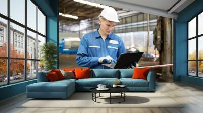 technician or engineer working on laptop computer in the factory Wall mural