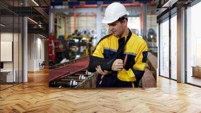 worker or engineer wearing bandages splint, pain in elbow and ache in arm from hard work in the factory Wall mural