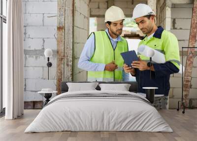 workers or architects meeting and working on tablet at construction site Wall mural