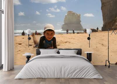 Boy laying at the beach in 12 Apostles, Port Campbell National Park, Victoria, Australia Wall mural