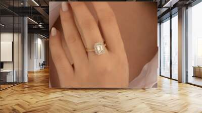 Beautiful lady's hand. woman wearing a white blouse and a diamond ring on her finger. Wall mural