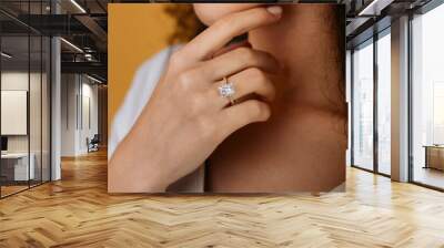 Close up of a blurred ring on woman's finger.Wedding and love concept. Wall mural