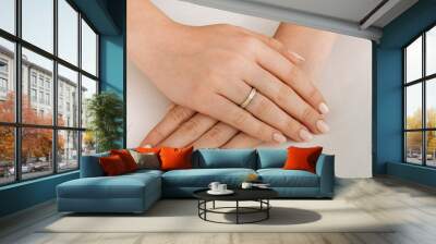 Golden Ring on a female hand, diamonds Diamond ring in hands of young lady. Close-up photo shoot Wall mural