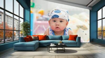 Newborn baby crawl on bed with a diaper cover his head with smile on his face, Cheerful little baby, Cute little male child, 5 month old child development. Wall mural