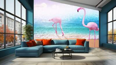 love couple pink flamingo on beautiful sandy beach and soft blue ocean wave summer concept background Wall mural