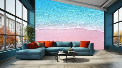 Soft blue ocean wave on pink sandy beach Wall mural