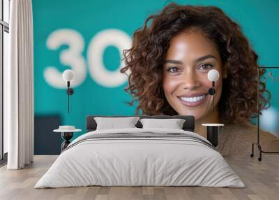 Confident African-American young woman smiling in a modern office setting Wall mural