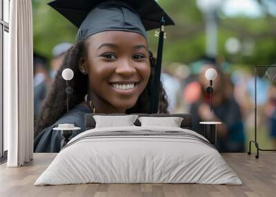 a radiant college graduate with smile. Dressed in her cap and gown,  she exudes pride and happiness.  Wall mural