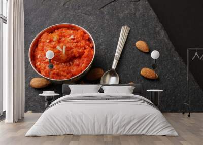 Gajar halwa is a carrot-based sweet dessert pudding from India. Garnished with Cashew almond nuts and Served in silver bowl Wall mural