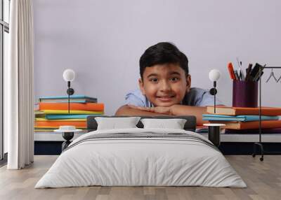 indian school boy or scholar kid with stack of books. Wall mural