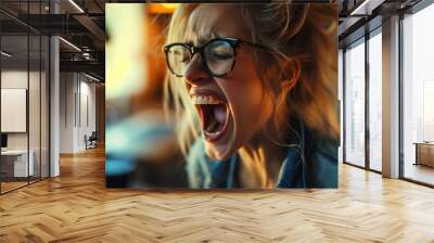 A woman wearing glasses, expressing anger or frustration by yelling and making an exaggerated facial expression. Wall mural