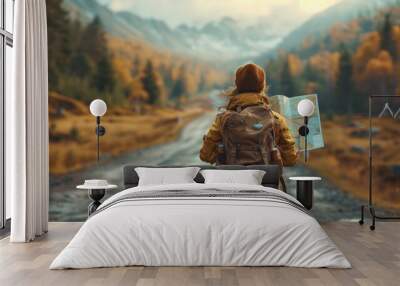 Solo traveler with map exploring autumn mountains on a misty day Wall mural