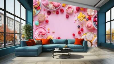 Delicious desserts and fresh fruits creating a frame with copy space on pastel pink background. Wall mural