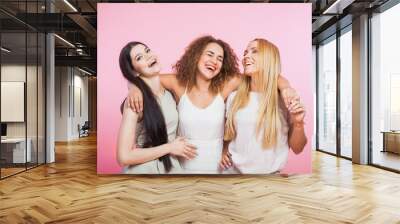 Three young women laughing and having fun Wall mural