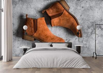 Classic suede brown women's chelsea boots on a gray background, top view Wall mural