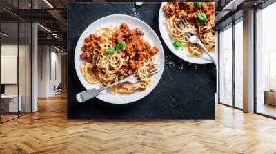 Mashed beans, mushrooms vegetarian bolognese sauce with spaghetti on a dark background, top view Wall mural